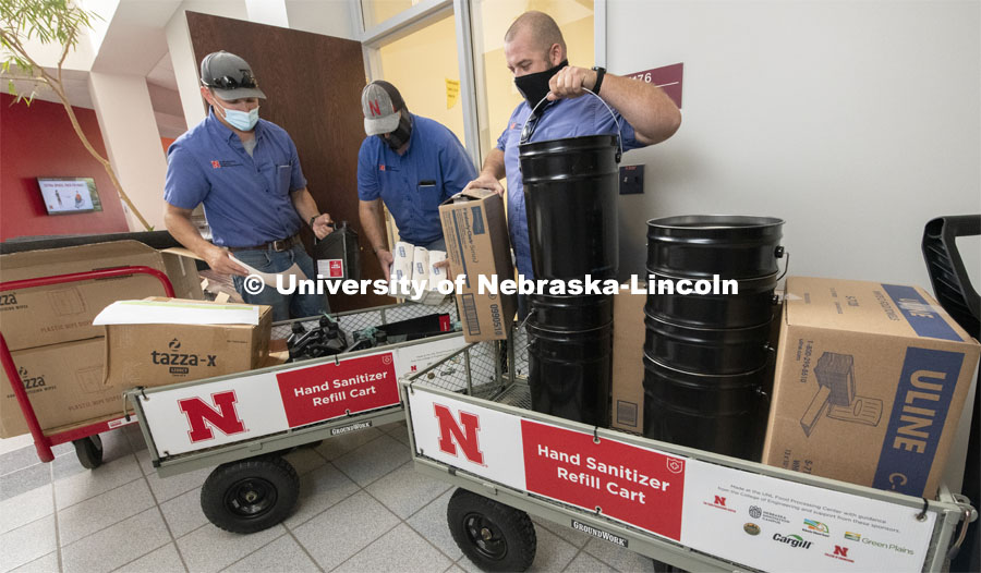 Nick Glass, James Soukup and Travis Smith of Building Systems Maintenance are distributing sanitizer products to classrooms. August 6, 2020. Photo by Gregory Nathan / University Communication.